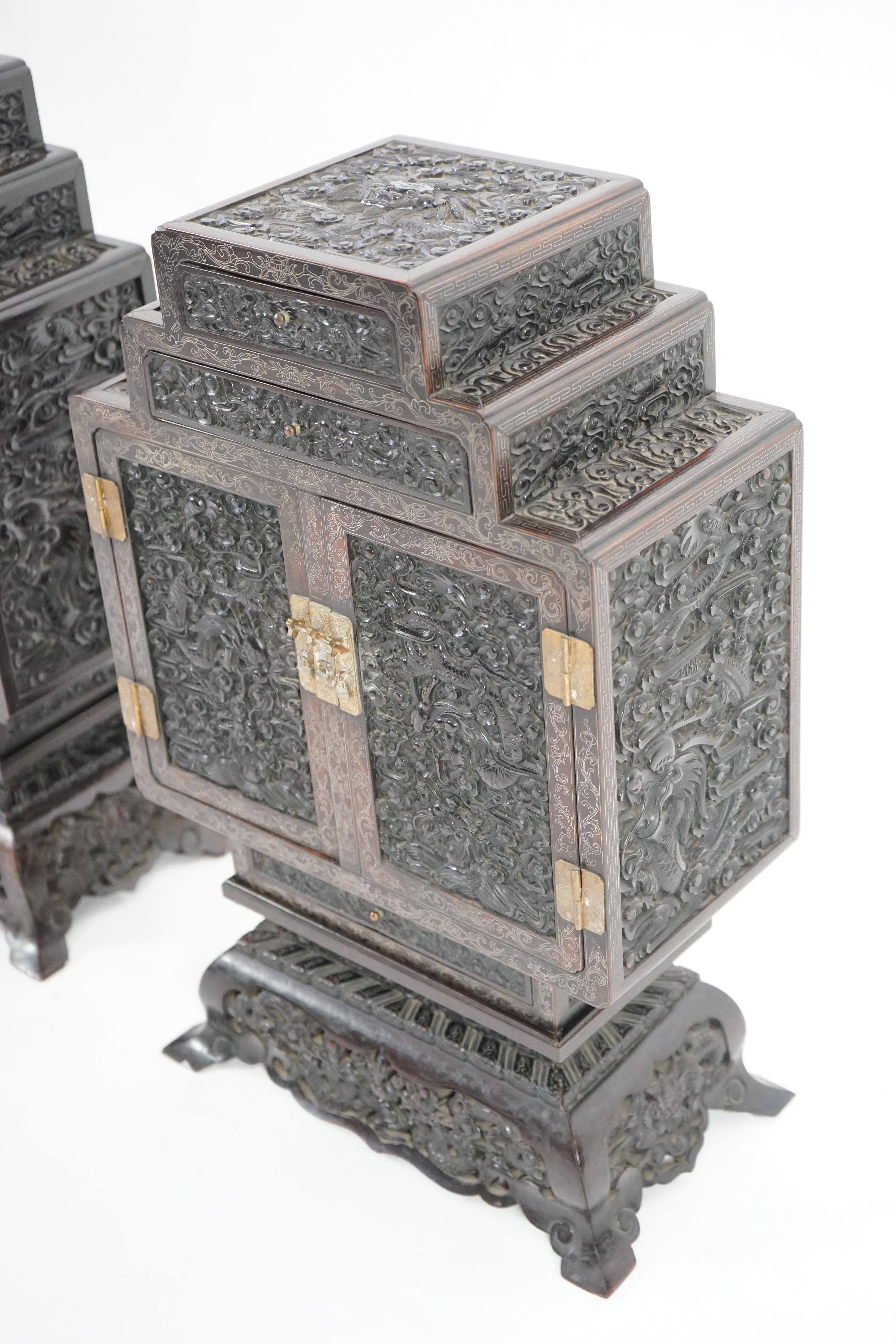 An important pair of Chinese carved zitan and silver wire inlaid ‘cloud and dragon’ curio cabinets and stands, duobaoge, probably Imperial, late Qing dynasty